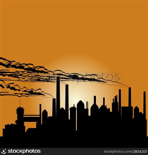 Circuit of industrial buildings and smoking chimneys against the setting sun.