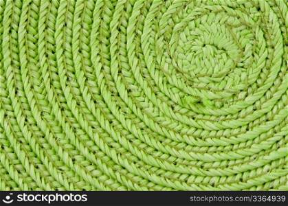 Circular background from green rattan fibers.