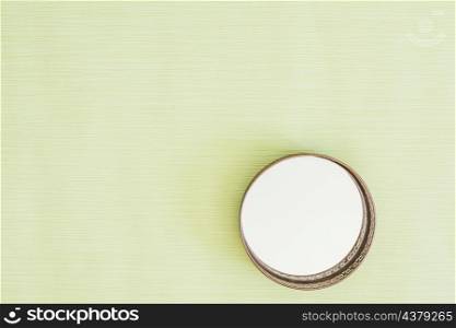 circular glass mirror mint green background