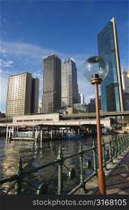 Circular Quay Railway Station in Sydney Cove with view of downtown skyscrapers and lammpost in Sydney, Australia.