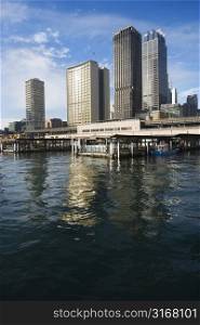 Circular Quay Railway Station in Sydney Cove with view of downtown skyscrapers in Sydney, Australia.