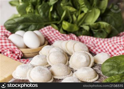 circular raw ravioli with spinach eggs