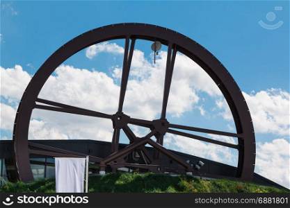 Circular Structure Wheel Mill Shaped: Modern Architectural Design and blue Sky in background