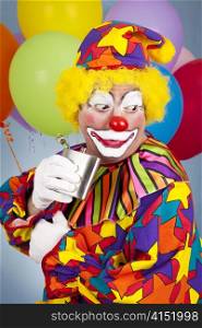 Circus clown sneaks a little nip of booze from his flask.