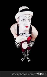 Circus clown with playing cards isolated on black background