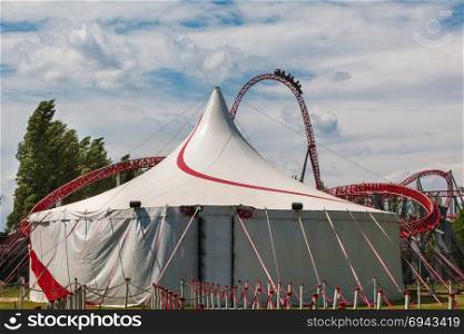 Circus Tent and Red Roller-coaster inside Public Amusement Park.. Circus Tent and Red Roller-coaster inside Public Amusement Park