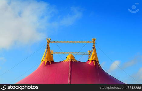 Circus tent red orange and pink four towers blue sky