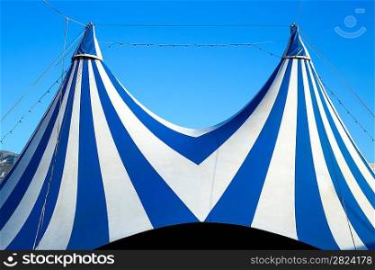 Circus tent stripped blue and white over clear sky