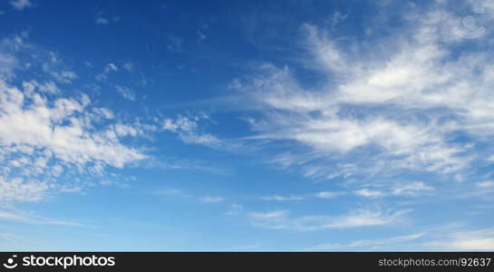Cirrus clouds against the dark blue sky. Heavenly background.