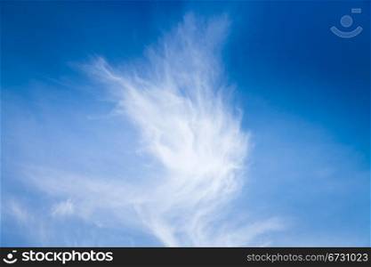 cirrus clouds in dark blue summer sky