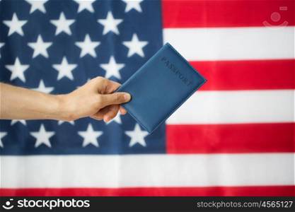 citizenship, patriotism and nationalism concept - close up of hand with american passport