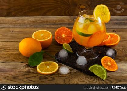 Citrus drink on wooden table. Fruit lemonade. Summer drink. Citrus lemonade. Fruit cocktail. Fruit drink. Citrus drink on wooden table