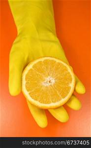 citrus fruit on human hand . isolated on orange background