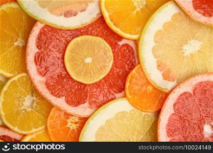 citrus fruits cut into round pieces  orange, grapefruit, lemon, tangerine. Ripe and juicy fruits, top view. citrus fruits cut into round pieces  orange, grapefruit, lemon, tangerine. Ripe and juicy fruits