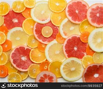 citrus fruits cut into round pieces  orange, grapefruit, lemon, tangerine. Ripe and juicy fruits, top view. citrus fruits cut into round pieces  orange, grapefruit, lemon, tangerine. Ripe and juicy fruits