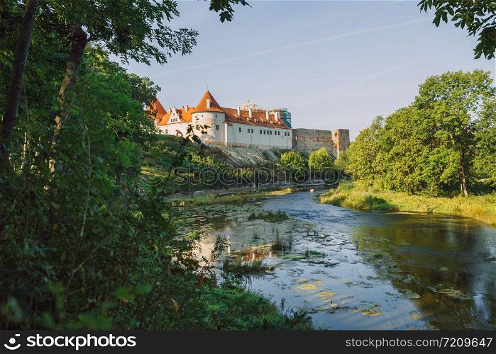City Bauska, Latvia Republic. Park with old castle and river. Trees and green zone. Sep 9. 2019 Travel photo.