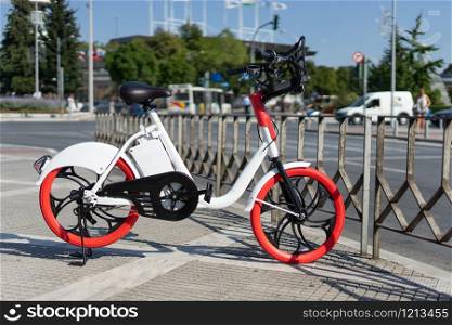 City bicycle Thessaloniki parked electric bike on the sidewalk ready for rent rental bikes services sharing service