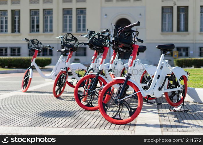 City bicycle Thessaloniki parked electric bikes on the sidewalk ready for rent rental bikes services sharing service