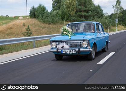 City Cesis, Latvia. Just merried, retro blue car with driver. Nature and way. Travel photo 2018. Love and romance.