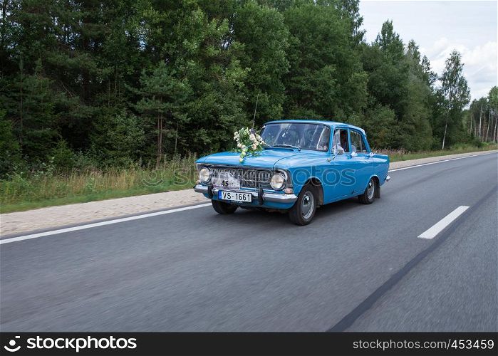 City Cesis, Latvia. Just merried, retro blue car with driver. Nature and way. Travel photo 2018. Love and romance.