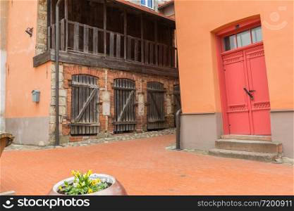 City Cesis, Latvia. Old orange house and red doors. Travel photo.11.04.2020.