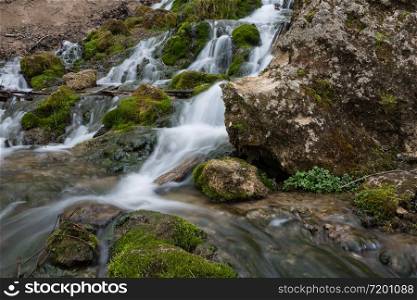 City Cesis, Latvia. Old waterfall with green moss and dolomite rocks.19.04.2020