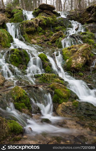 City Cesis, Latvia. Old waterfall with green moss and dolomite rocks.19.04.2020