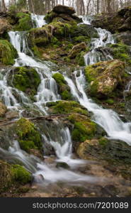 City Cesis, Latvia. Old waterfall with green moss and dolomite rocks.19.04.2020