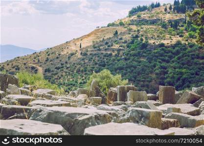 City Delphi. Greek Republic. Ancient Greek ruins and columns from ancient times. Walking tourists. 13. Sep. 2019.