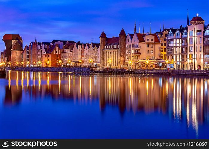 City embankment and facades of medieval houses in the old city at dawn. Gdansk. Poland.. Gdansk. City embankment at dawn.