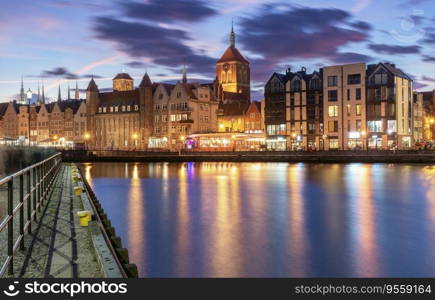 City embankment and facades of medieval houses in the old town at sunset, Gdansk. Poland.. City embankment in night illumination at blue hour, Gdansk. Poland.