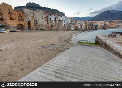 City embankment in the old medieval town of Cefalu at dawn. Italy. Sicily.. Cefalu. Sicily. Old city.