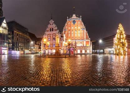 City Hall Square in the Old Town of Riga, Latvia. City Hall Square with House of the Blackheads, illuminated Christmas tree and Saint Roland Statue in Old Town of Riga at night, Latvia