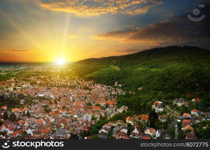 City in a mountain valley and the sunrise view from above