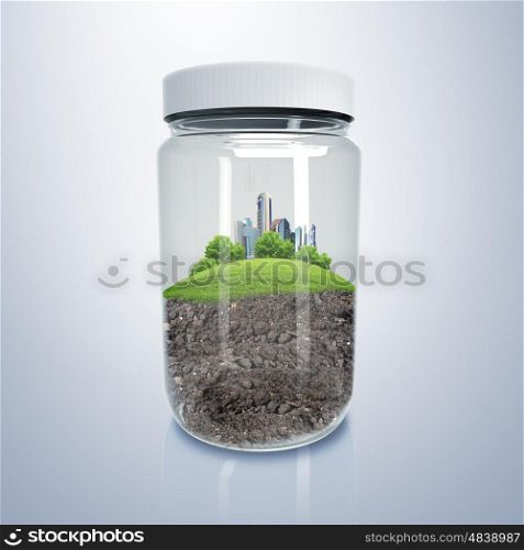 City inside a glass jar. Green city on the hill inside a glass jar