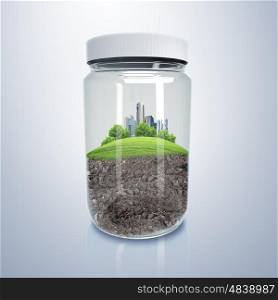 City inside a glass jar. Green city on the hill inside a glass jar