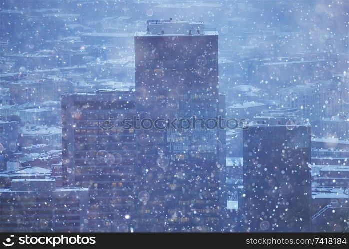 city lights snow glow background blurred / cityscape blurred bokeh, snowy weather seasonal background winter December