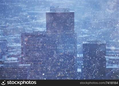 city lights snow glow background blurred / cityscape blurred bokeh, snowy weather seasonal background winter December