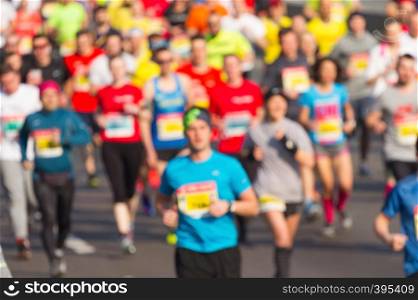 City marathon of blurred people runners