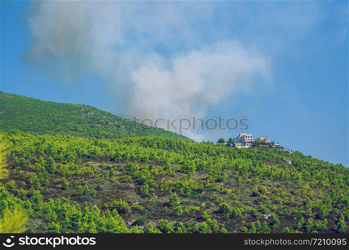 City Moni Osiou Patapiou, Greek Republic. Mountains and fire smoke. 14. Sep. 2019