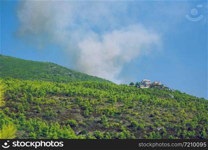 City Moni Osiou Patapiou, Greek Republic. Mountains and fire smoke. 14. Sep. 2019
