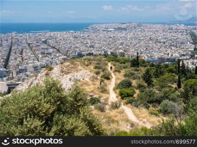 City of Athens to Piraeus port taken from the summit of Filopappou Hill. Panorama of city of Athens from Filopappou Hill