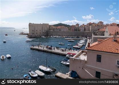 City of Dubrovnik with boats and castle on a clear sky