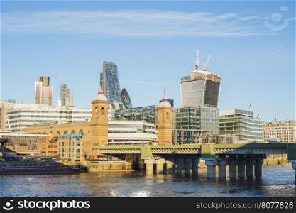 City of London on Thames. Sun light and blue sky