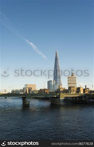 City of London on Thames. Sun light and blue sky
