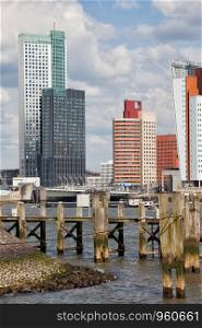 City of Rotterdam downtown skyline and wooden pier on Nieuwe Maas (New Meuse) river in Netherlands, South Holland province.