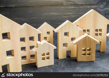 City of wooden figurines of houses. Buying and selling real estate. Renovation and home improvement. Mortgage loan. Building maintenance. Renting housing, realtor services.