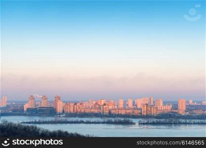 City on the river in sunset. View on cityscape with buildings, Kiev, Ukraine