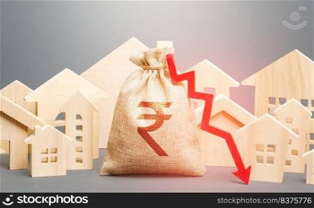 City residential buildings and indian rupee money bag with a red down arrow. Low cost of real estate. Falling prices for rental apartments. Low demand for home buying. Lower mortgage interest rates.