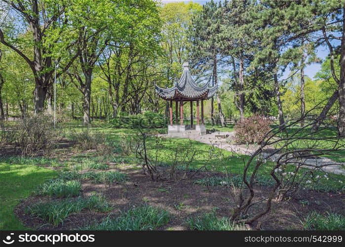 City Riga, Latvia Republic. City park with china gazebo. Trees and nature. May 7. 2019 Travel photo.